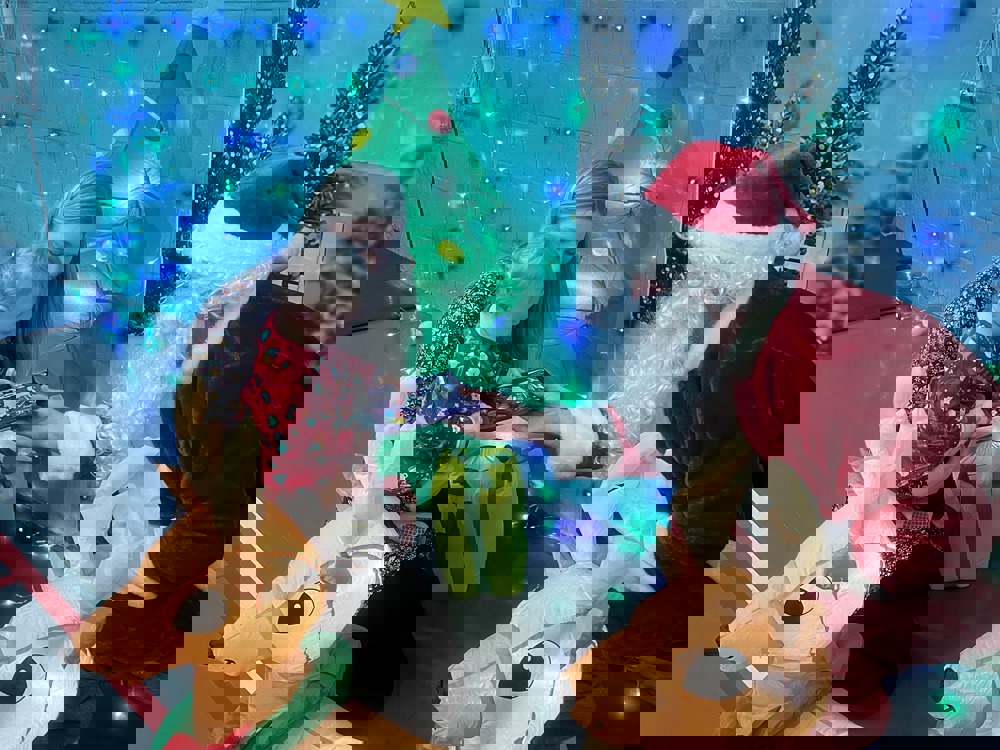 Santa giving a present to child in a leisure centre