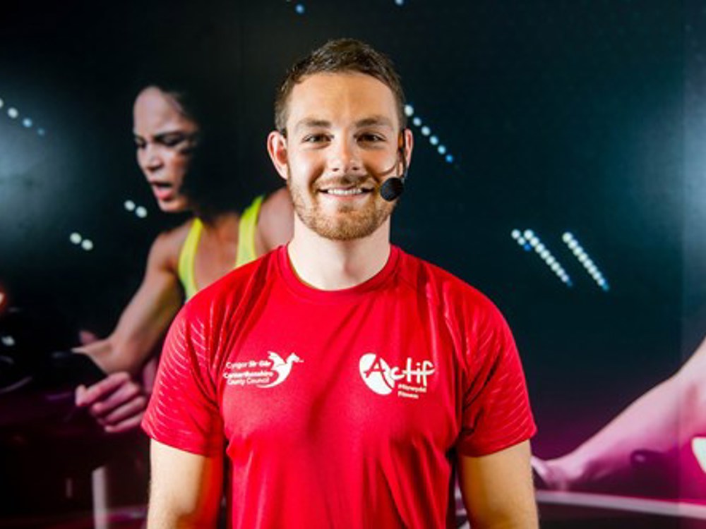 Fitness instructor staring directly at you with microphone headset