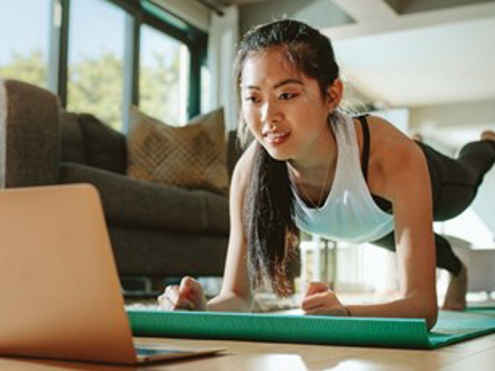woman doing a workout using the laptop