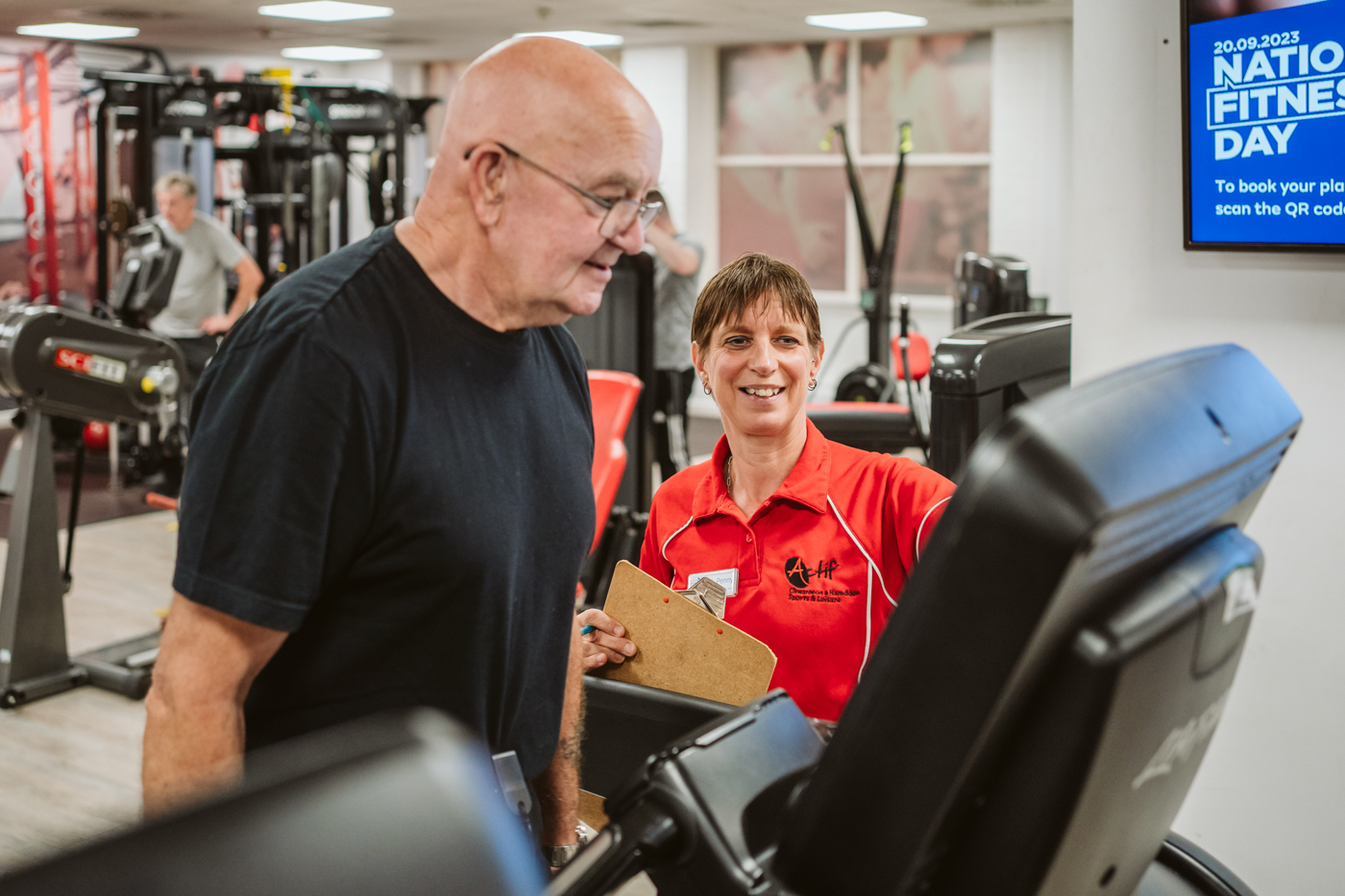 a customer with an instructor on treadmill